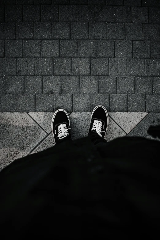 an image of person wearing tennis shoes and laying down