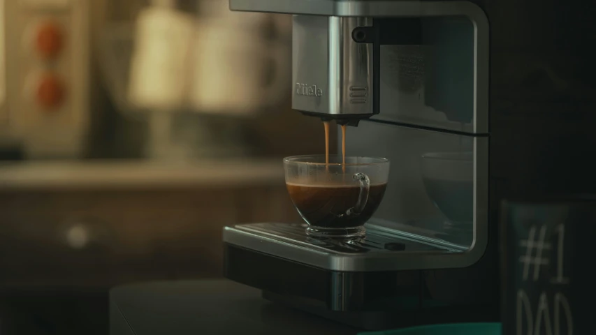 someone making an espresso in a coffee machine