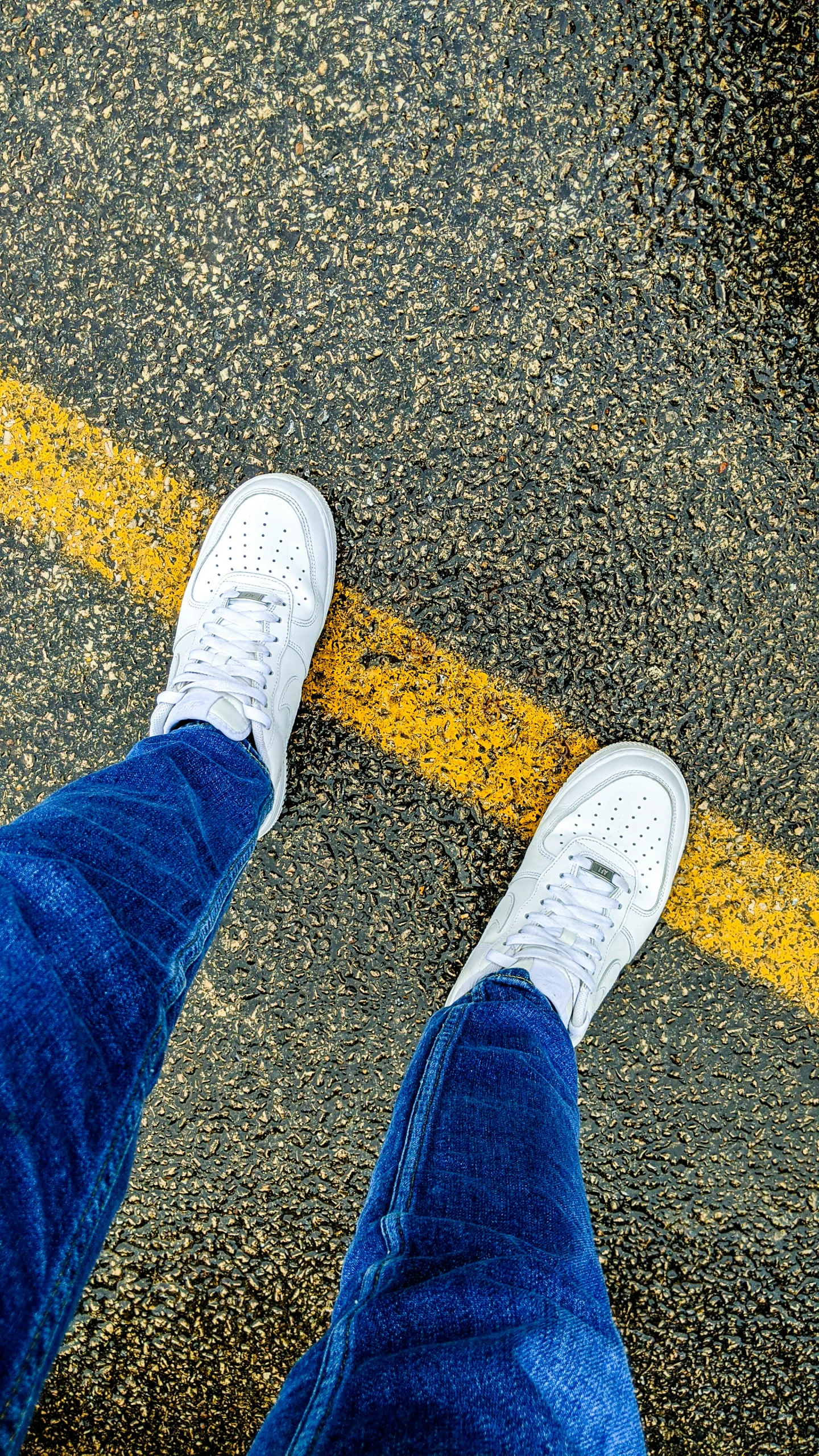 the feet of a person wearing a white sneakers
