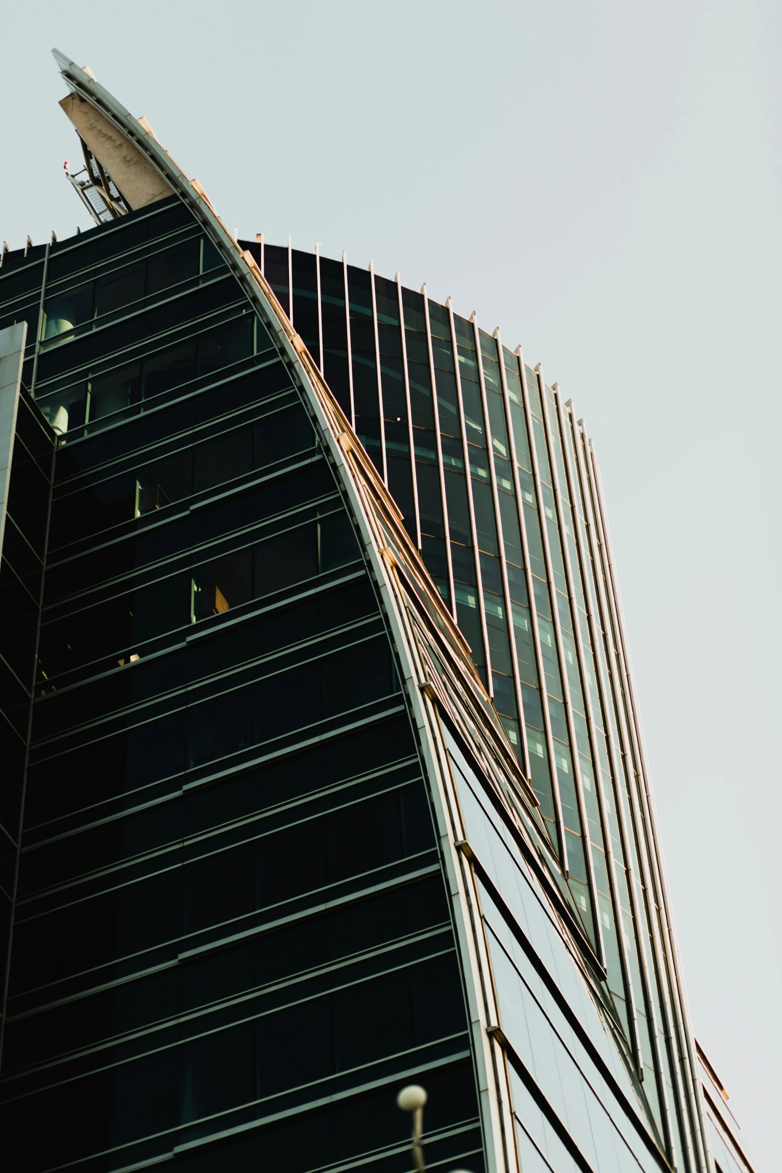 a very tall building with a large bird in it's hand