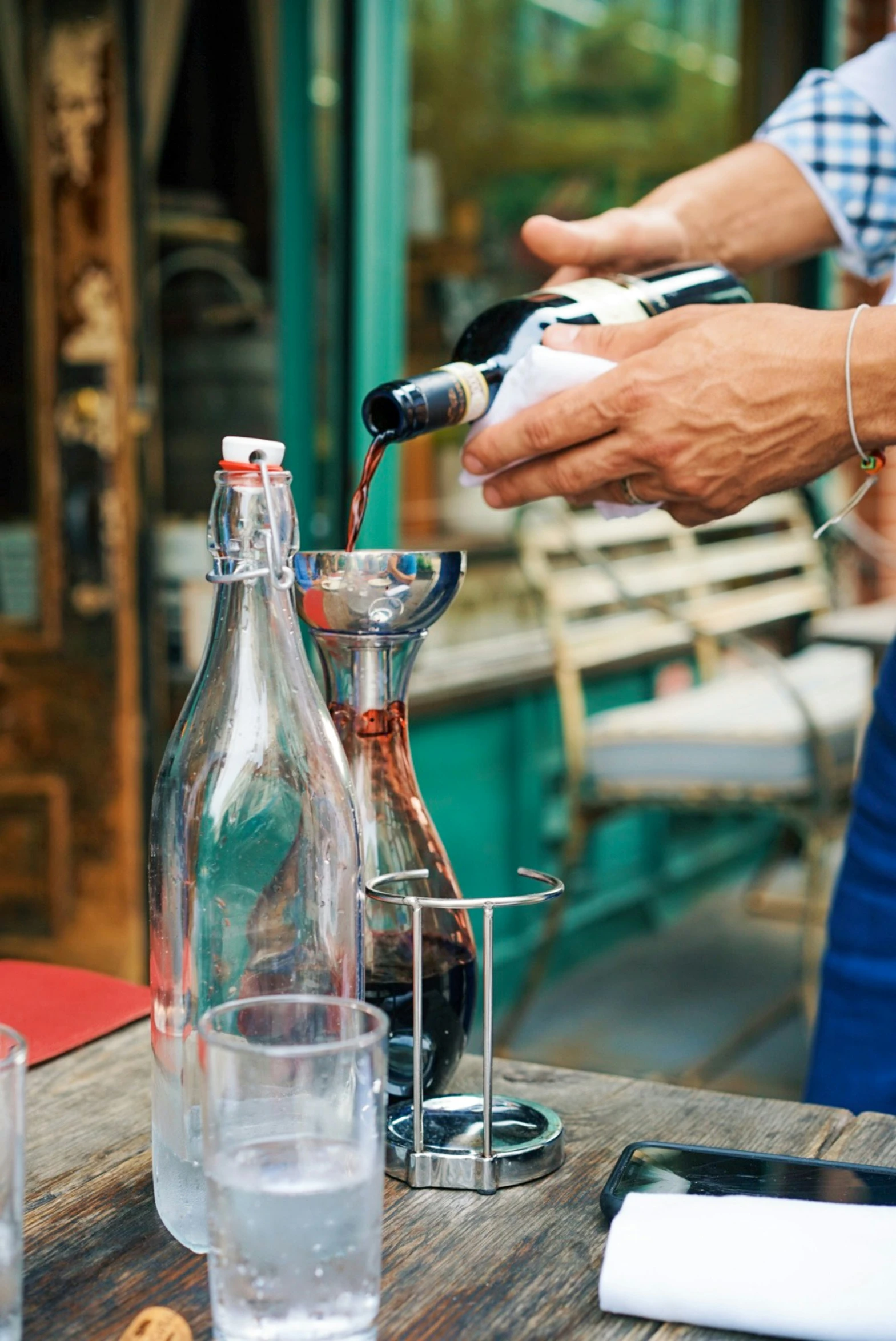 a person holding soing on a table with glasses