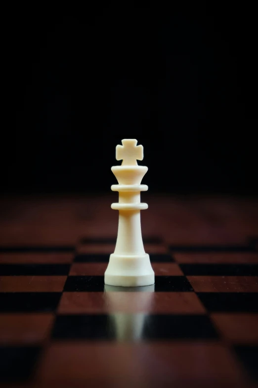 a single white chess piece on a dark background