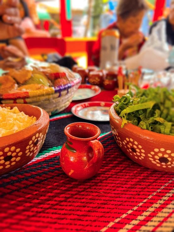 a table with a bunch of bowls filled with food