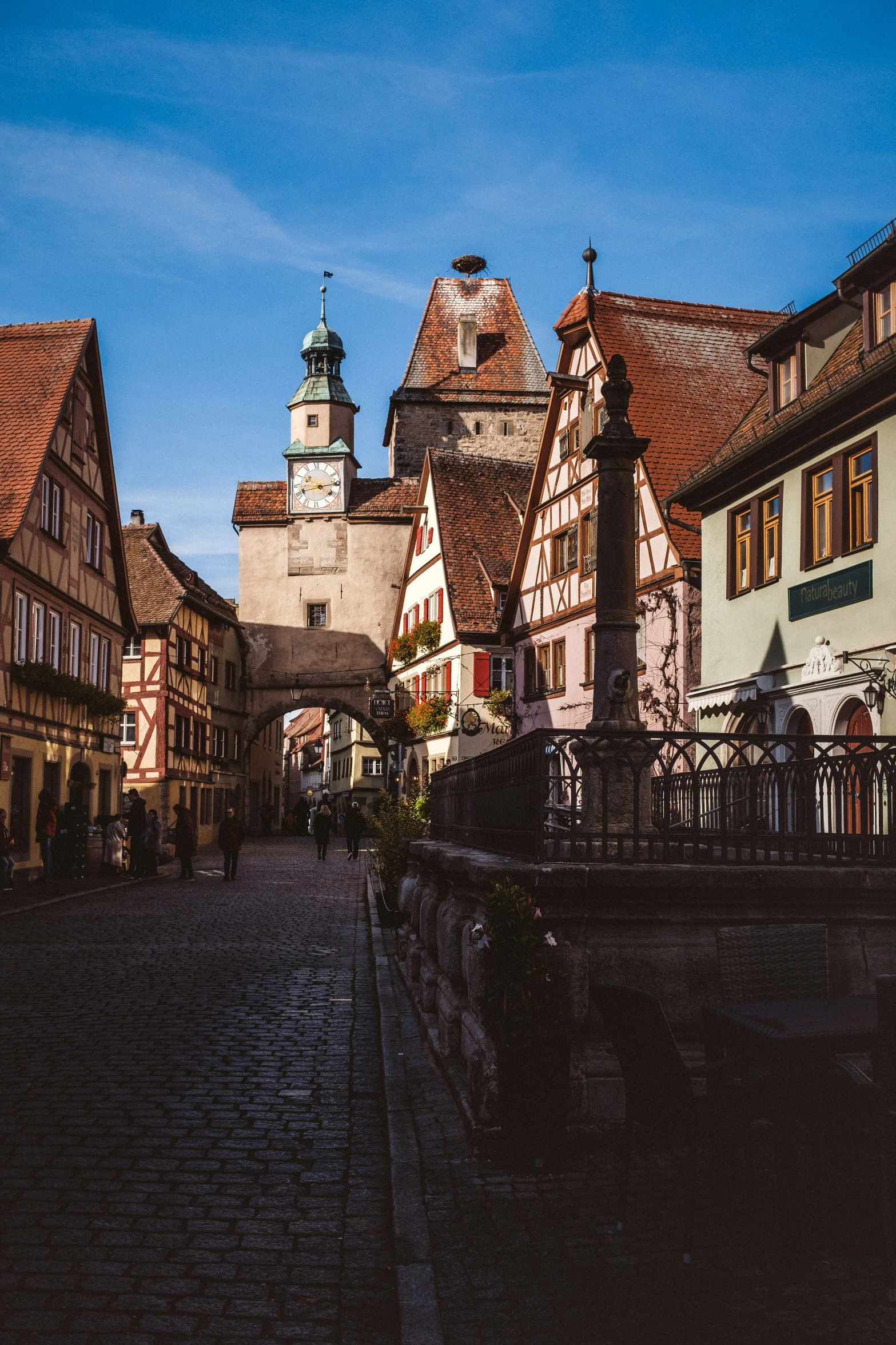 two tall brown buildings sit on the side of a street