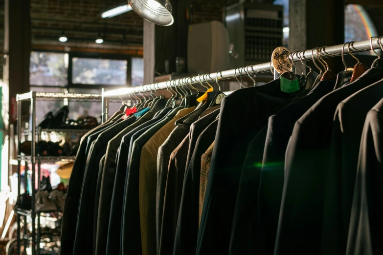 a rack of shirts and pants with hanging clothes