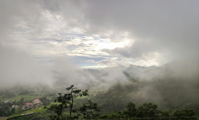 clouds and rain rolling through the valley with trees