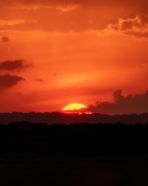 a very colorful sky with some clouds at sunset