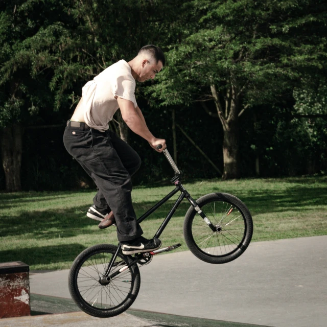 a man riding a bicycle up the side of a ramp