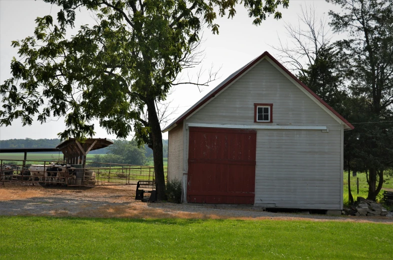 a barn with a red door is shown