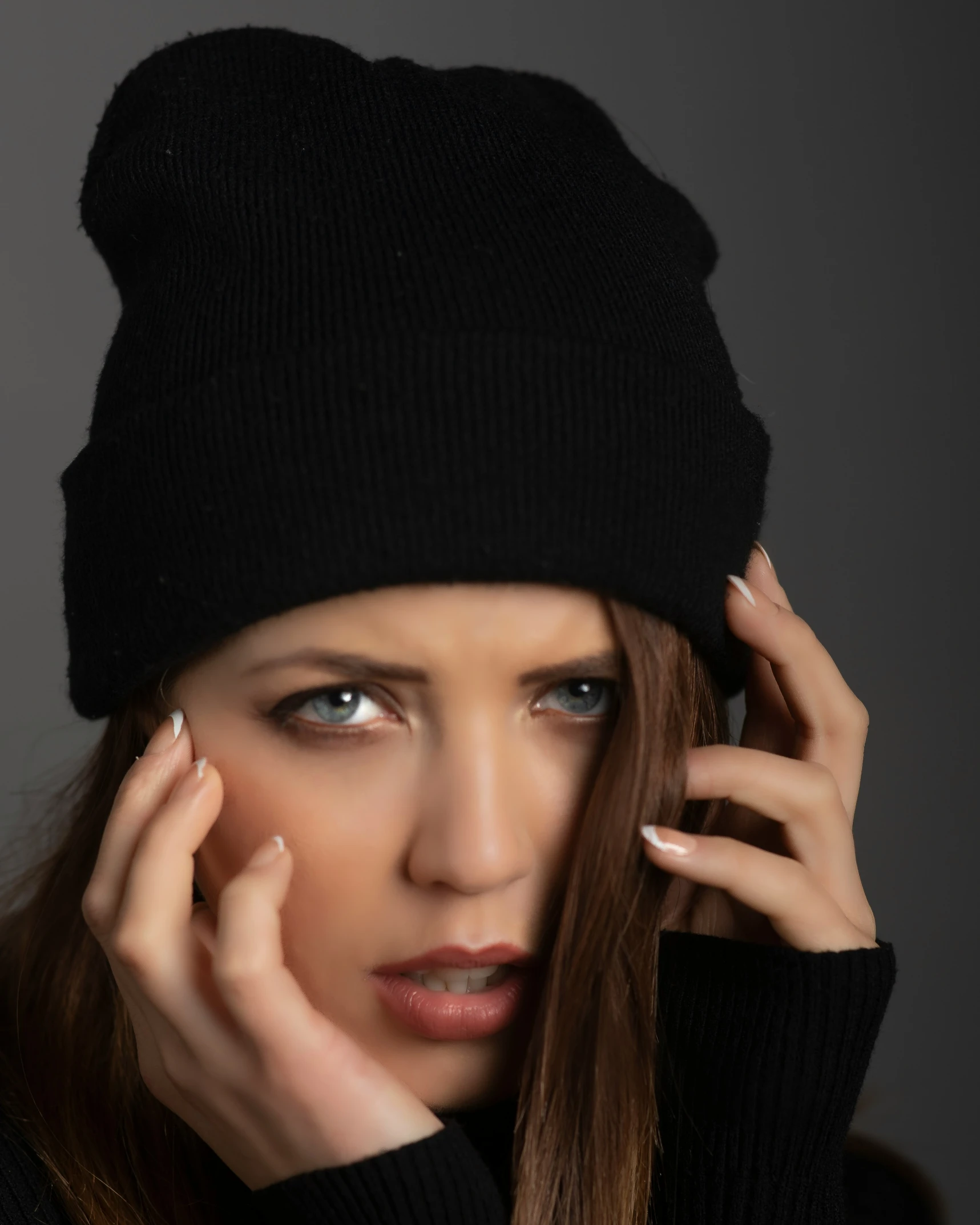 a woman with blue eyes and long nails