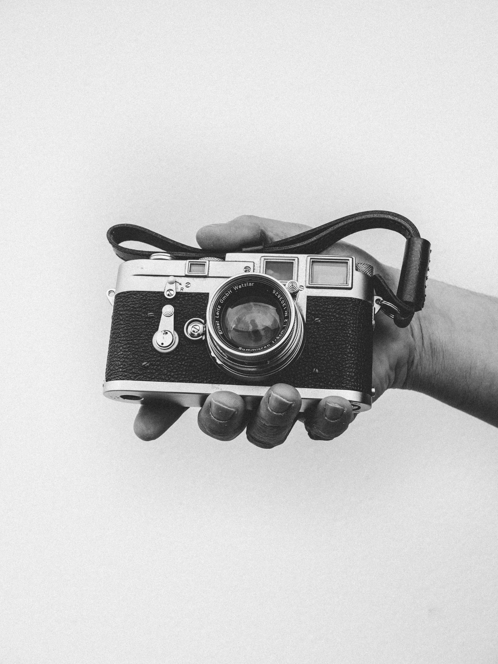 a person holds a small camera in their hand