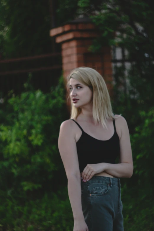 a blond female is posing for the camera