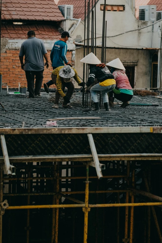 a group of people are working on the roof of their house