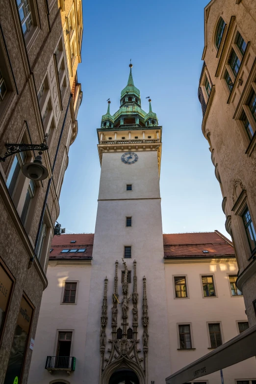 an architectural structure with a steeple and large clock at the top