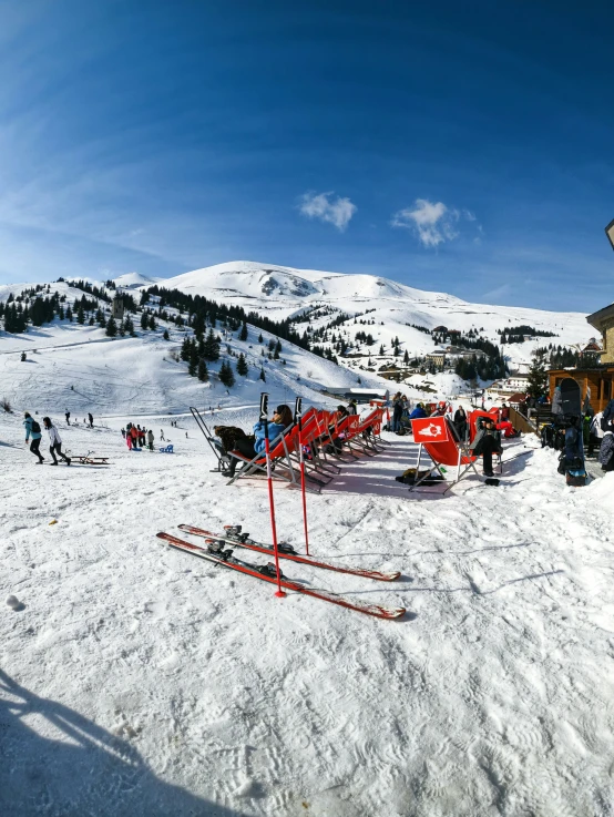 some skiers on the snow with buildings