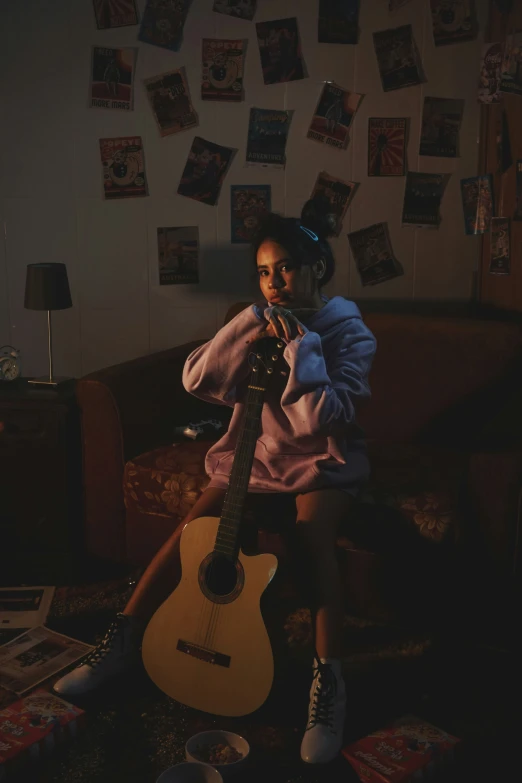 a girl plays an ukulele while sitting in her living room