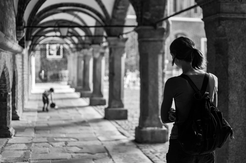 a woman standing in the middle of a hallway