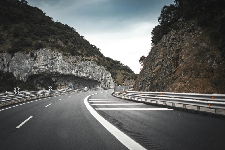 an empty road with several lanes going into a cave