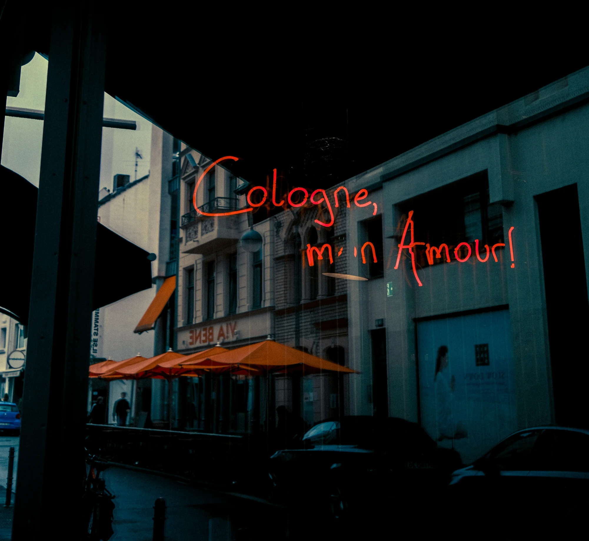 a view of a restaurant from the street during the night