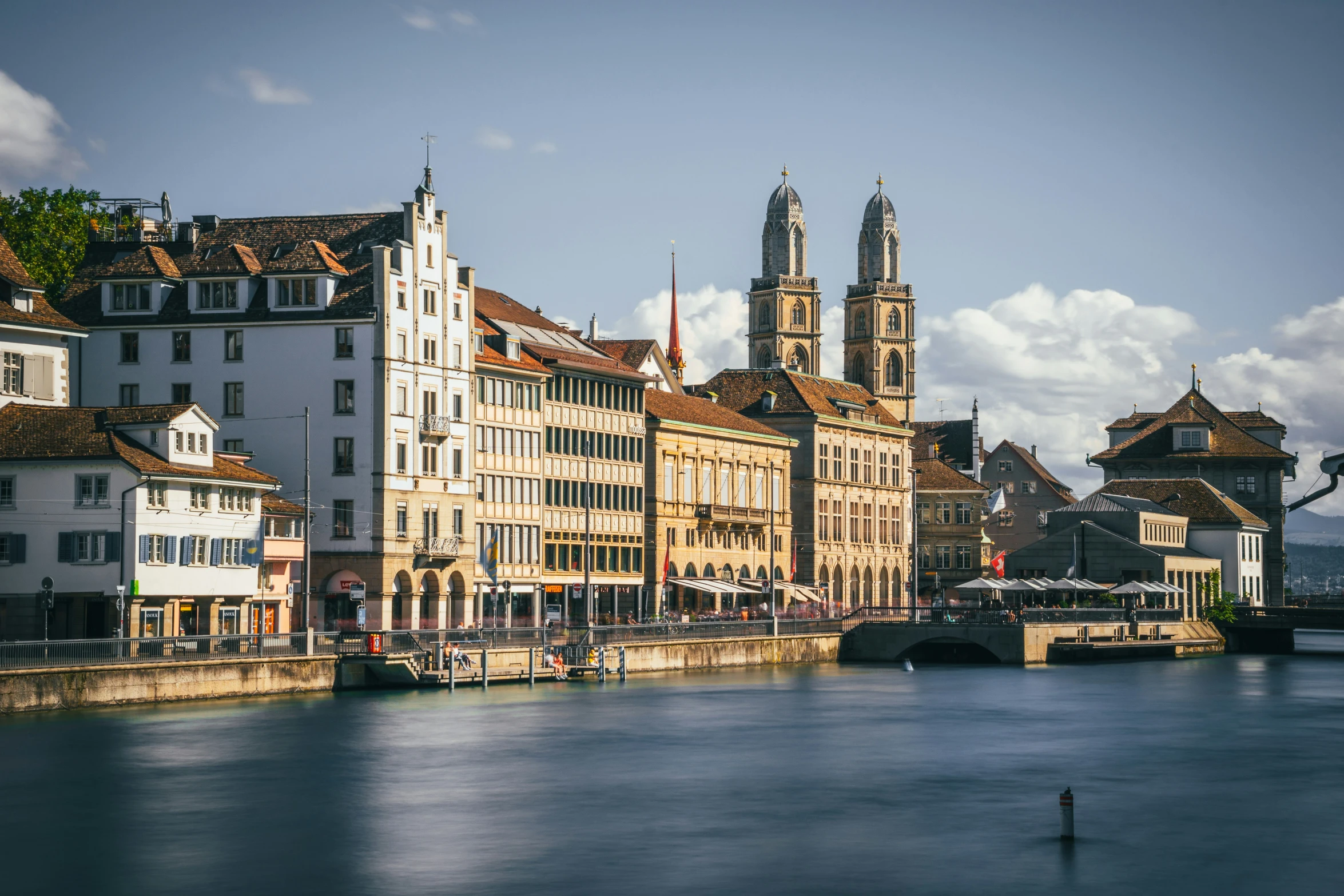 buildings on the side of a river with one boat out front