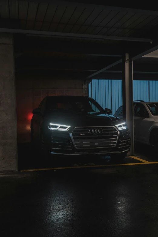 two cars are parked in an underground parking lot