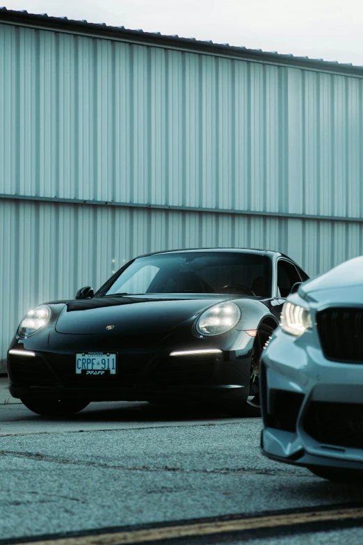 two white cars sitting next to each other in front of a building