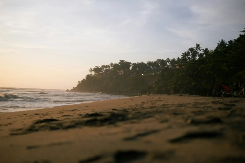 a sandy beach next to the ocean