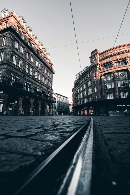 a view from the side of a railway line as they pass by tall buildings