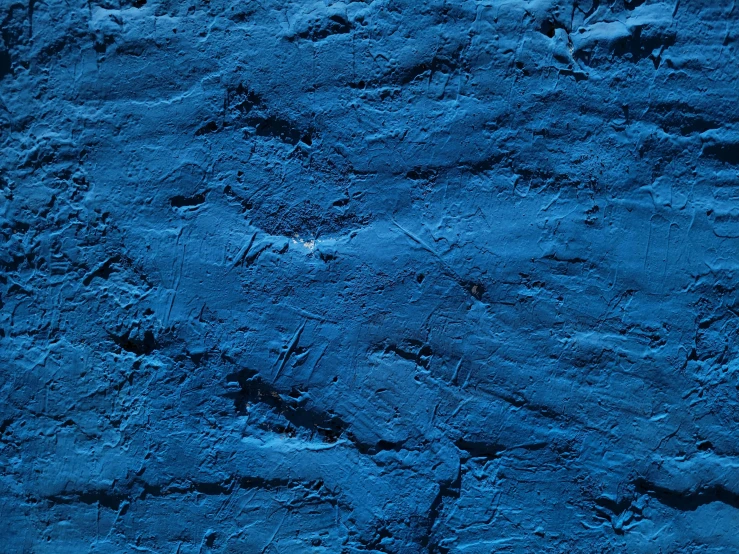 a blue stone background with some black spots