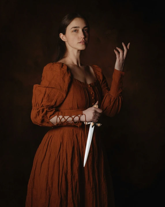 a woman in a red dress holding a white knife