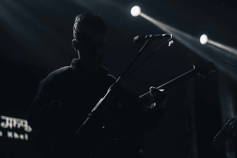 a man that is holding a guitar in his hands