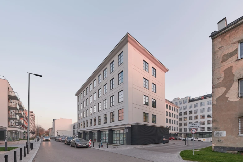 an apartment building next to a couple of other buildings on a street