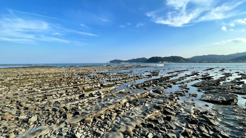 rocks are on the shore by the water