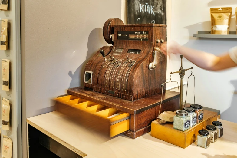 a person trying to remove some type of paper from the machine