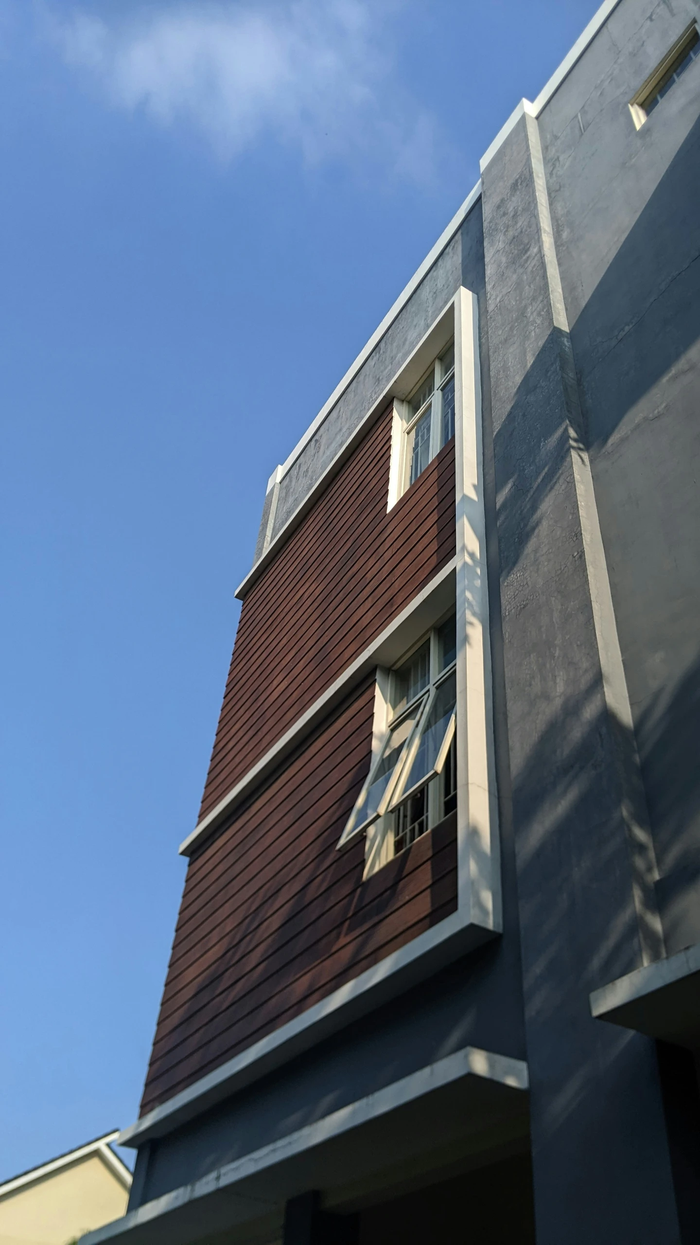 the house has an open window and a view of the sky