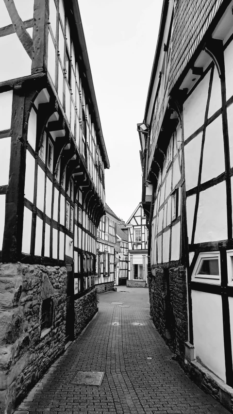 black and white pograph of buildings and cobblestones