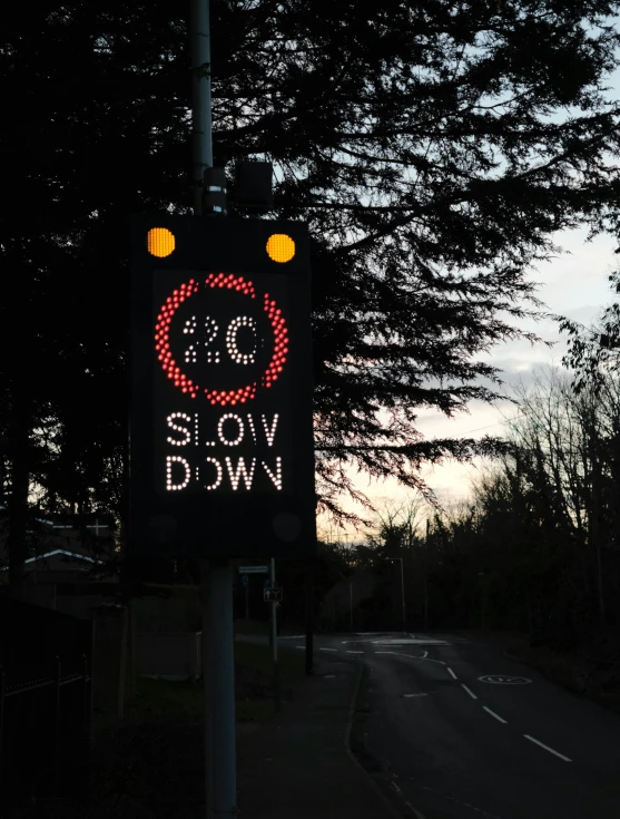 a street sign with the word slow down written below it