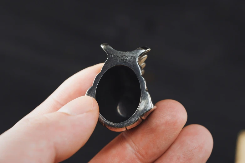 a close up of a small ring with a bird on it