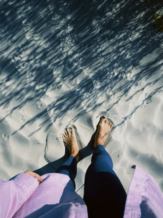 an aerial view of two people on the beach