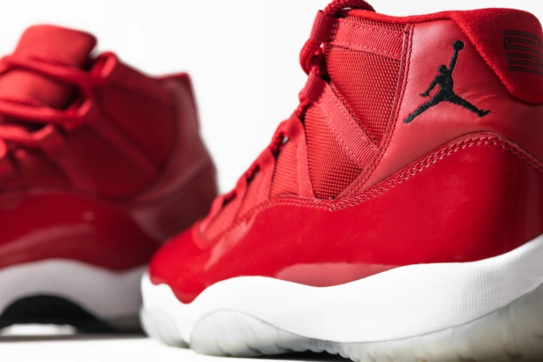 a pair of red shoes with the jordan logo on the top