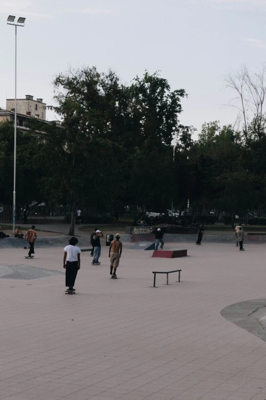 a couple of people are standing around in a park