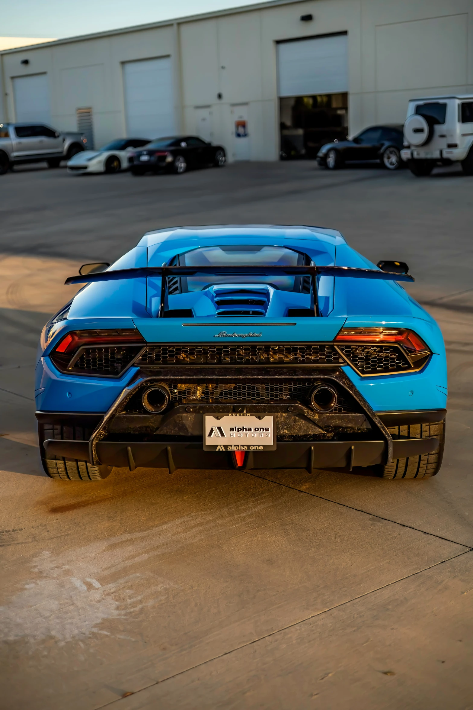 a lamb - powered vehicle sits parked in front of a warehouse