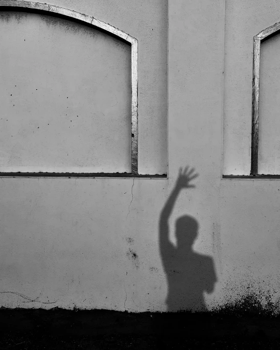 a child casts a shadow on a wall