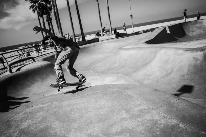 a man riding a skateboard on a cement ramp