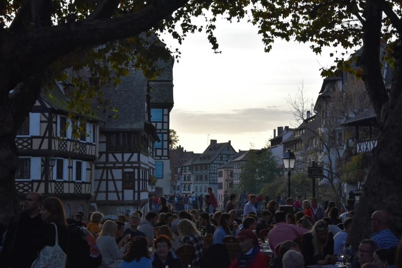 the crowd is gathered around a town street