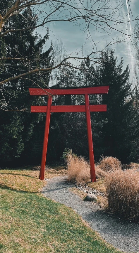 a red wooden structure sitting on top of a green field