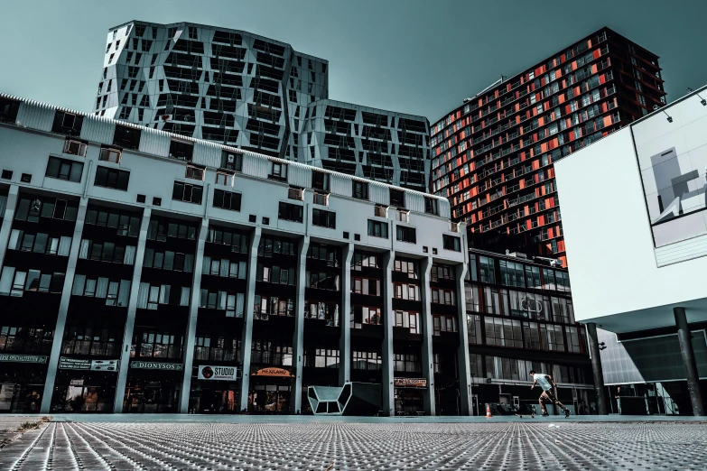 some very tall buildings near by some concrete blocks