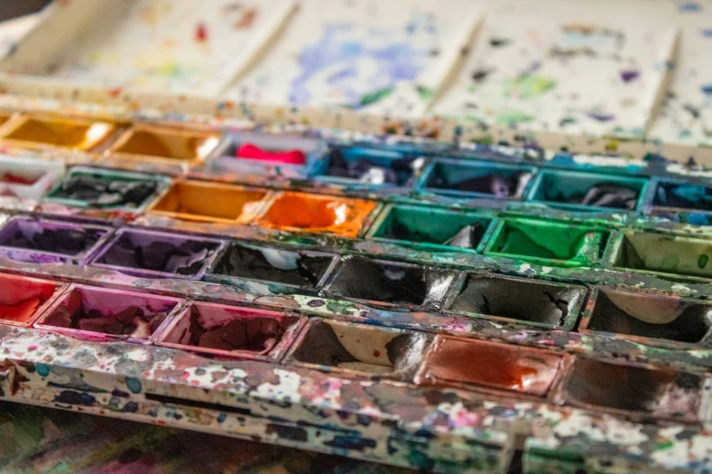 several boxes of paint are being displayed on a table