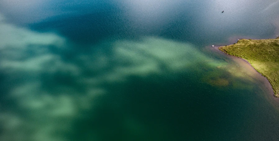 green land in the middle of a body of water