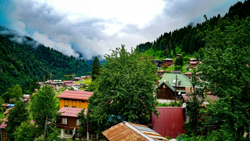 small village on a hillside surrounded by mountains